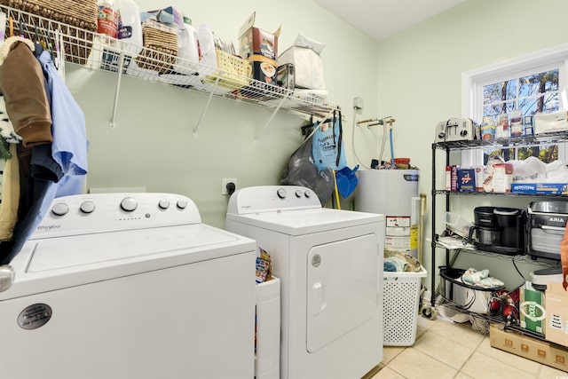 laundry room with light tile patterned floors, electric water heater, and separate washer and dryer