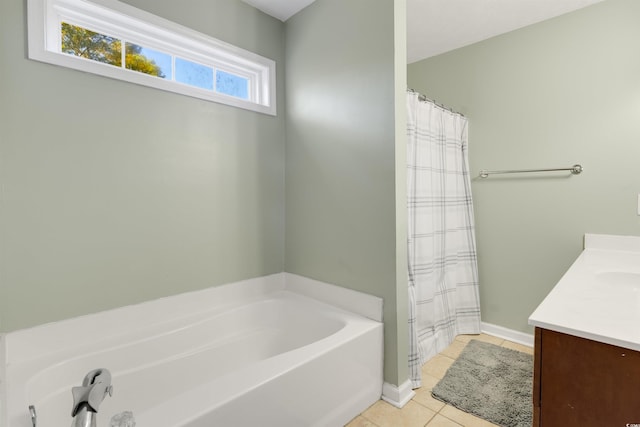 bathroom featuring tile patterned flooring, vanity, and a bath