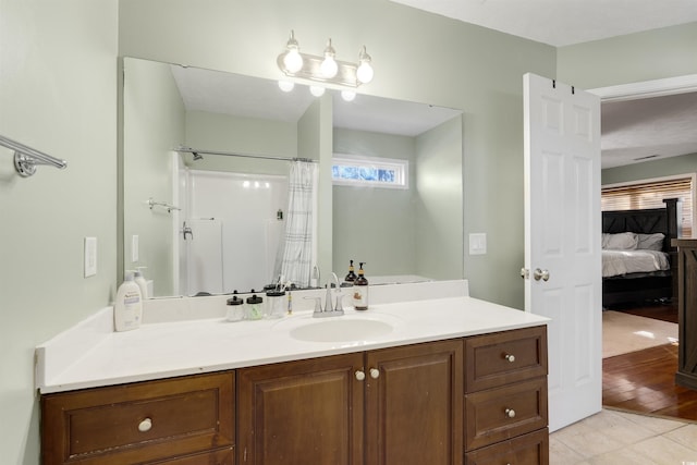 bathroom featuring curtained shower, hardwood / wood-style floors, and vanity