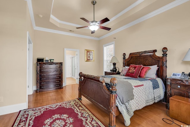 5603 Leatherleaf Dr, North Myrtle Beach, SC 29582 - bedroom featuring wood finished floors, a tray ceiling, crown molding, and ceiling fan