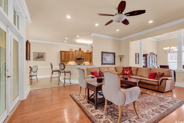5603 Leatherleaf Dr, North Myrtle Beach, SC 29582 - living area with a chandelier, a ceiling fan, recessed lighting, light wood-style flooring, and ornamental molding