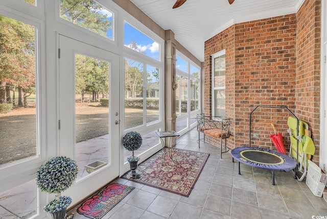 sunroom with ceiling fan and a healthy amount of sunlight