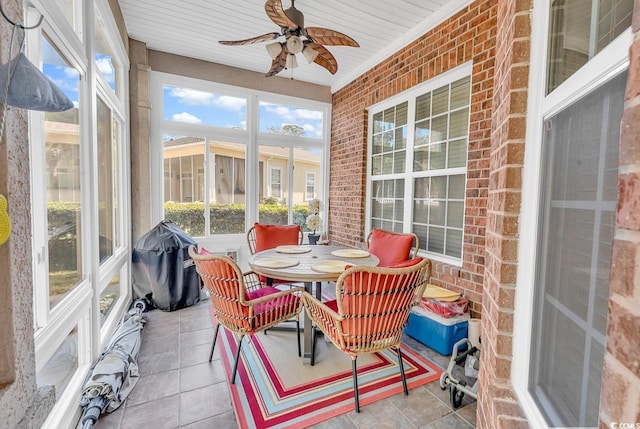 sunroom / solarium featuring ceiling fan