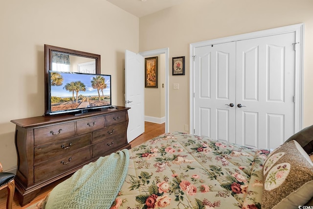 bedroom with hardwood / wood-style flooring and a closet