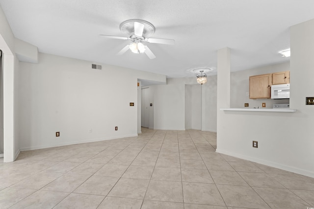 unfurnished living room featuring light tile patterned floors and ceiling fan with notable chandelier