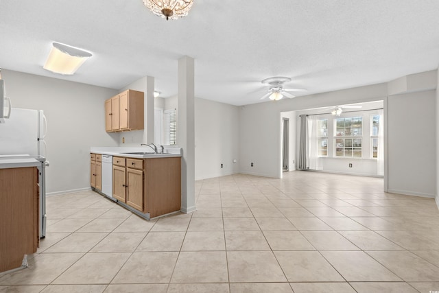 kitchen featuring a textured ceiling, white appliances, ceiling fan, sink, and light tile patterned flooring