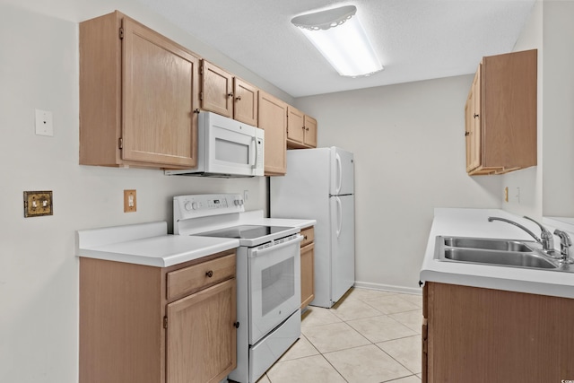 kitchen featuring sink, a textured ceiling, white appliances, light brown cabinetry, and light tile patterned floors