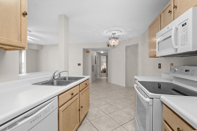 kitchen with white appliances, sink, light brown cabinets, decorative light fixtures, and light tile patterned flooring