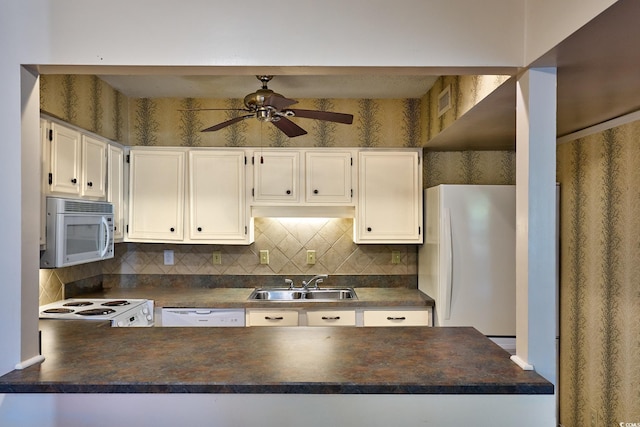 kitchen with white appliances, white cabinets, sink, decorative backsplash, and ceiling fan