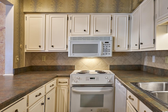 kitchen featuring white cabinetry, sink, white appliances, and backsplash