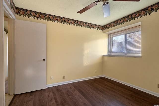 empty room featuring ceiling fan, dark hardwood / wood-style flooring, and a textured ceiling