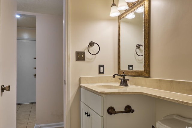 bathroom featuring tile patterned floors, vanity, and a textured ceiling