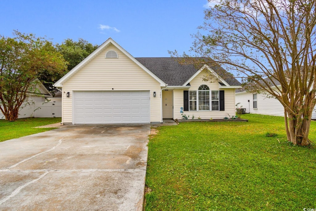 single story home featuring a garage and a front lawn