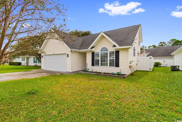 view of front of house featuring cooling unit, a garage, and a front lawn