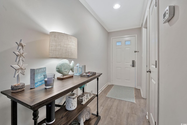 entrance foyer with light wood-type flooring and ornamental molding