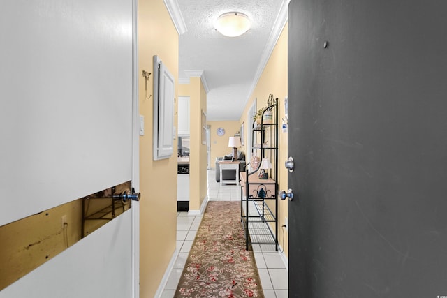 hallway with light tile patterned floors, a textured ceiling, and ornamental molding