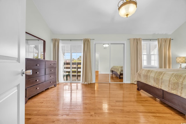 bedroom featuring lofted ceiling and light wood-type flooring