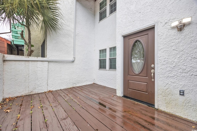 property entrance featuring a wooden deck