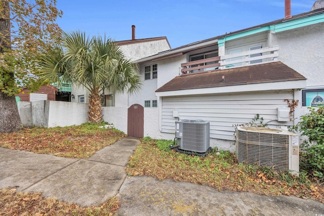 rear view of house featuring a balcony and cooling unit