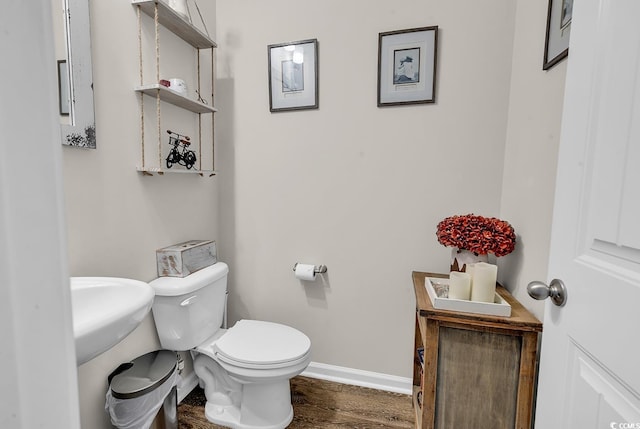 bathroom featuring hardwood / wood-style floors and toilet