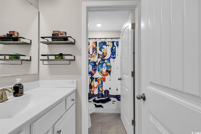 bathroom featuring tile patterned floors, a shower with curtain, vanity, and toilet