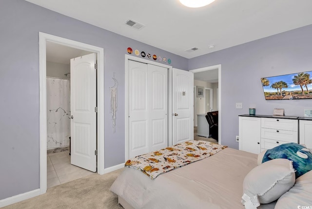 carpeted bedroom featuring ensuite bathroom and a closet