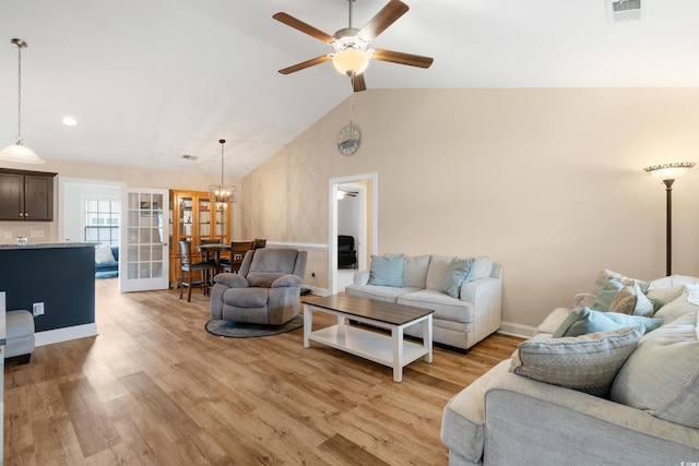 living room featuring ceiling fan, light hardwood / wood-style floors, lofted ceiling, and french doors