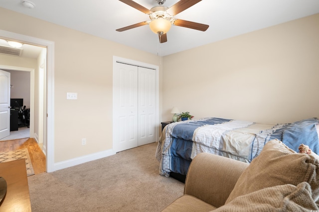 bedroom with light carpet, a closet, and ceiling fan