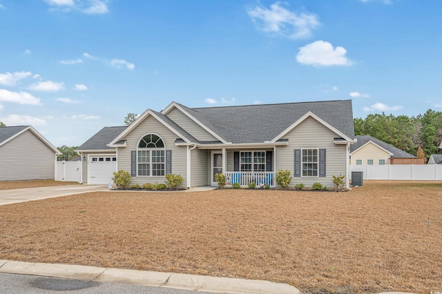 ranch-style home featuring covered porch and a garage