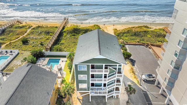 birds eye view of property with a view of the beach and a water view