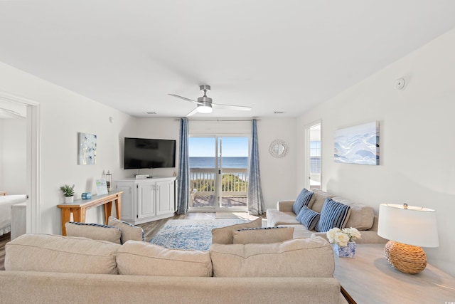 living room with hardwood / wood-style floors and ceiling fan