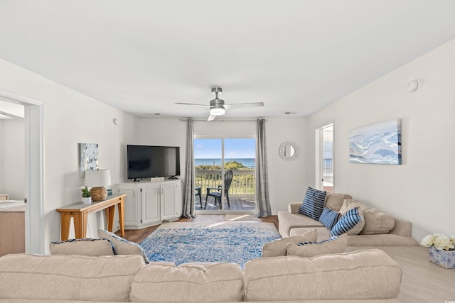 living room featuring ceiling fan and light hardwood / wood-style flooring