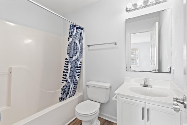 full bathroom with hardwood / wood-style floors, vanity, shower / tub combo with curtain, and toilet