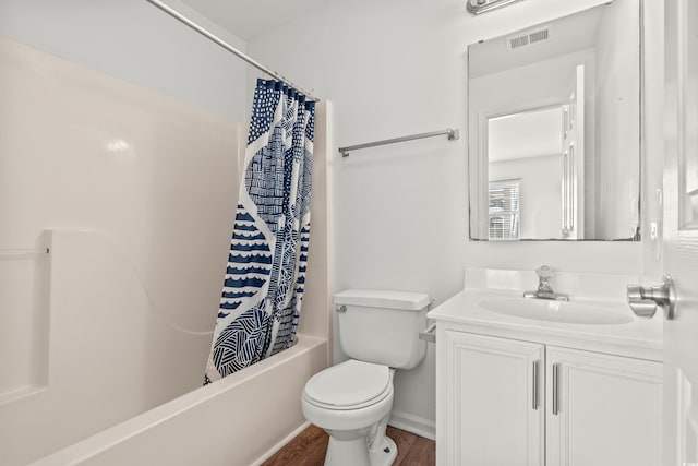 full bathroom with hardwood / wood-style floors, vanity, toilet, and shower / bath combo with shower curtain