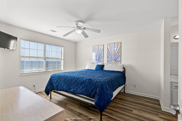 bedroom featuring ensuite bath, ceiling fan, and dark hardwood / wood-style floors