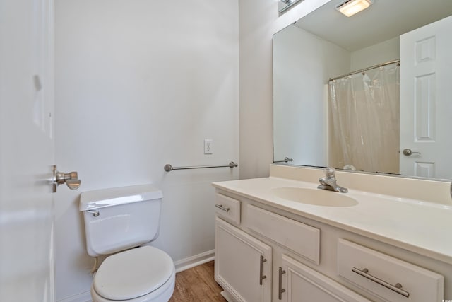 bathroom with vanity, hardwood / wood-style flooring, and toilet