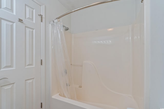 bathroom featuring shower / bath combo with shower curtain