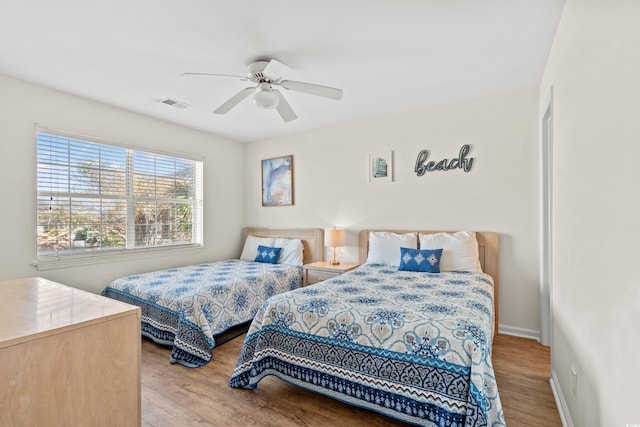 bedroom with hardwood / wood-style floors and ceiling fan