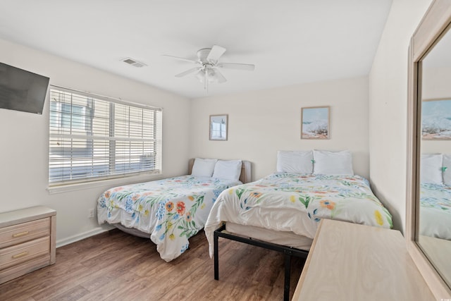 bedroom with ceiling fan and hardwood / wood-style floors