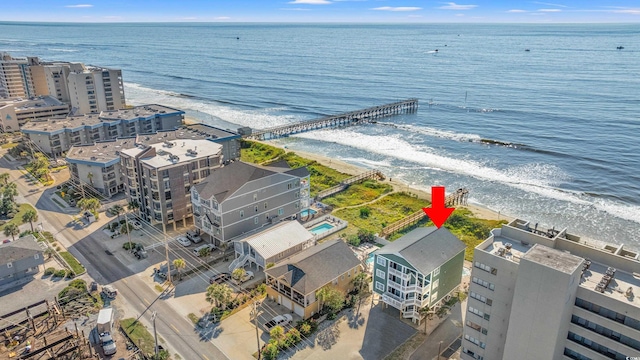 drone / aerial view featuring a water view and a view of the beach