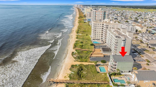 birds eye view of property with a water view and a view of the beach