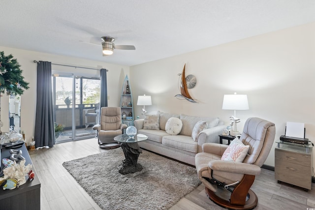 living room featuring light hardwood / wood-style flooring and ceiling fan