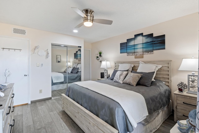 bedroom featuring ceiling fan, light hardwood / wood-style floors, and a closet