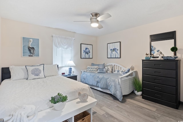 bedroom with ceiling fan and light hardwood / wood-style flooring