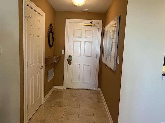 entryway with light tile patterned floors