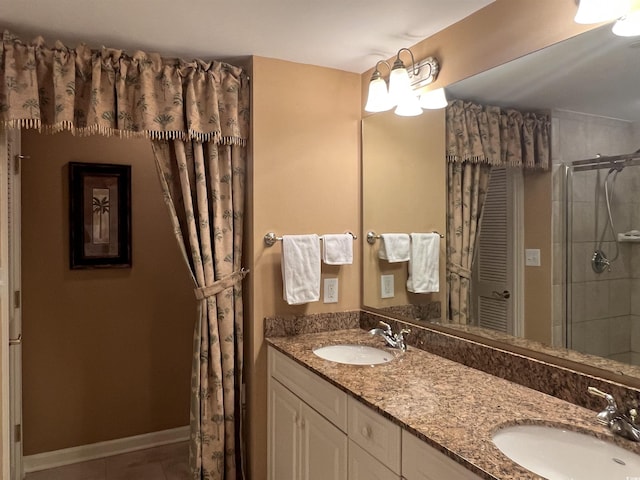 bathroom featuring tile patterned floors, vanity, and an enclosed shower