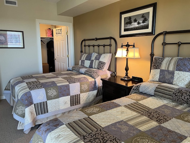 bedroom featuring carpet flooring, a spacious closet, and a closet