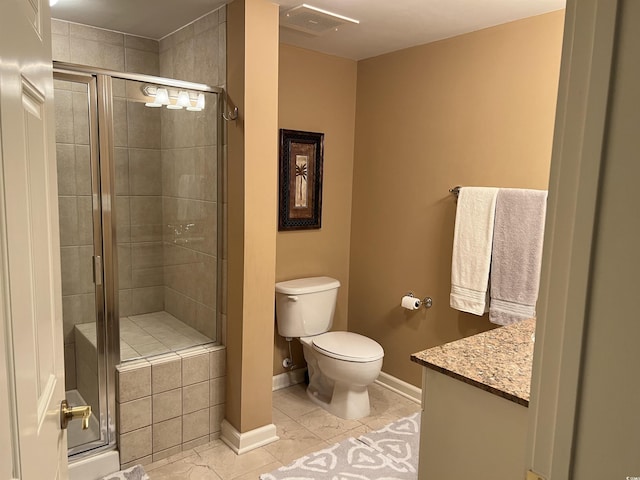 bathroom with toilet, vanity, tile patterned floors, and an enclosed shower