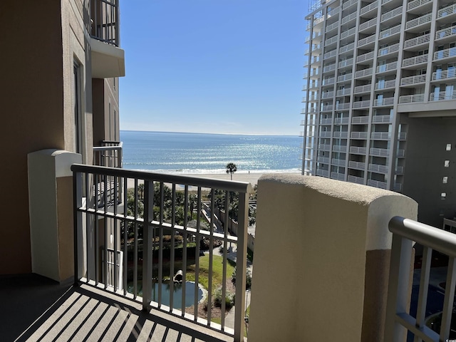 balcony with a view of the beach and a water view