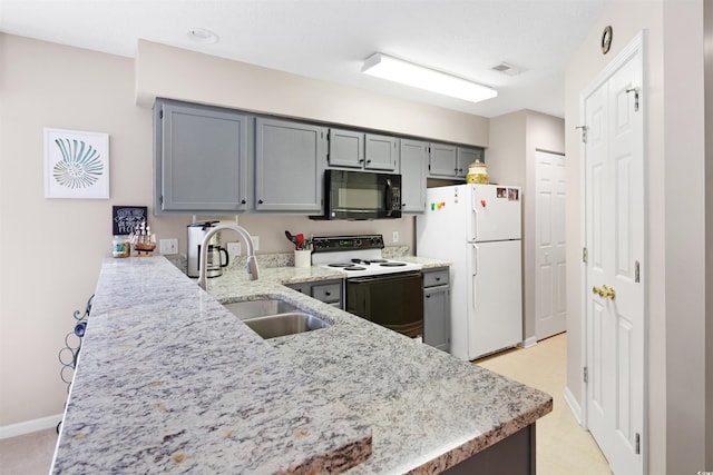 kitchen with gray cabinetry, light stone countertops, sink, kitchen peninsula, and white appliances